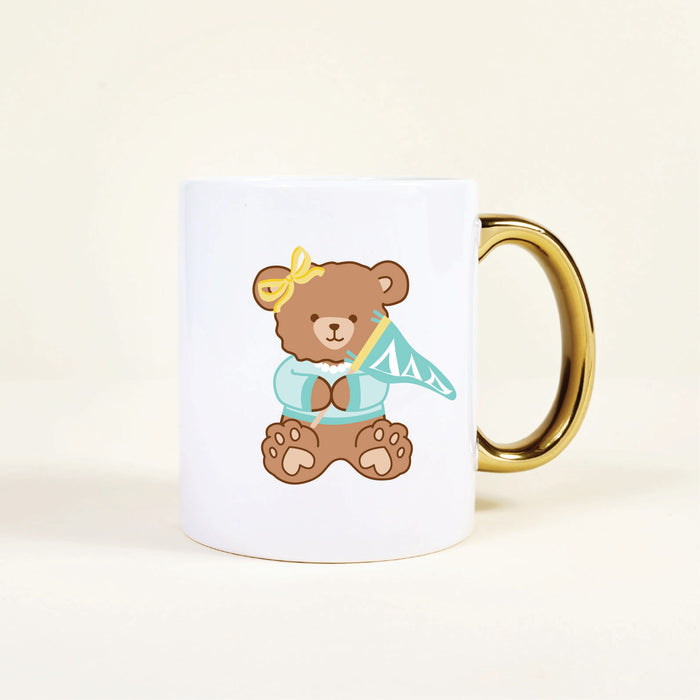 The Darling Effect's Delta Delta Delta 11 oz Cozy Cute Ceramic Mug features a ceramic teddy bear with a shiny gold handle—perfect for sorority celebrations and cozy moments.