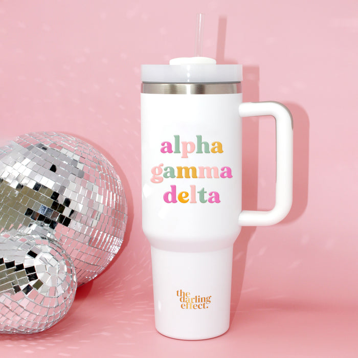 The Darling Effect Alpha Gamma Delta 40 oz Take Me Everywhere White Tumbler features colorful lettering and the brand’s logo.