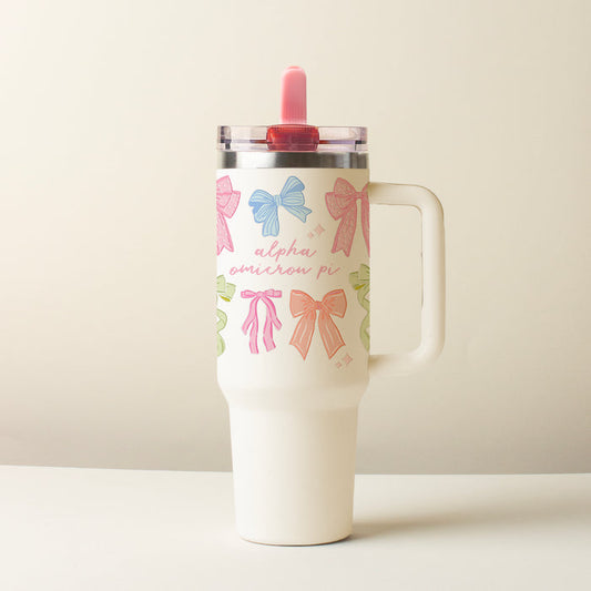 The Darling Effect’s Alpha Omicron Pi 40 oz Lifestyle Flip Straw Tumbler Bow Affair features a tall white design with colorful bows, pink script, a handle, clear lid, and pink straw—perfect for stylish, spill-free sipping.