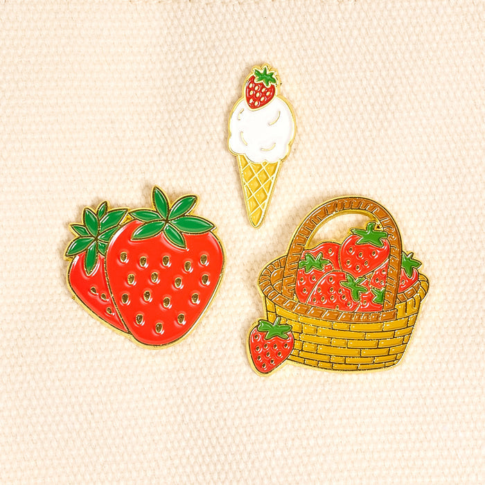 Berrylicious The Pin Pack by The Darling Effect: three vibrant enamel pins—a pair of strawberries, a strawberry-topped ice cream cone, and a woven basket of berries. Perfect for unique, expressive accessories and pin collections.