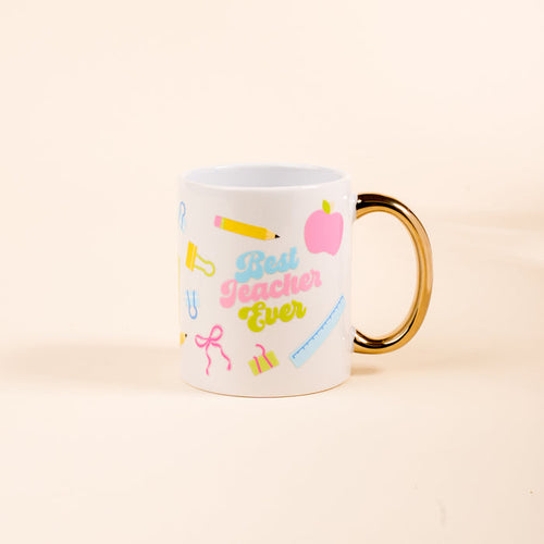 The Darling Effect's Best Teacher Ever 11 oz Cozy Cute Ceramic Mug features a gold handle and school-themed icons—a pink apple, yellow pencil, and ruler—making it the perfect gift for teachers to enjoy coffee or tea.