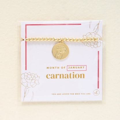The Darling Effect Birth Flower Beaded Charm Bracelet features a gold beaded design with a round carnation-engraved charm for January, displayed on a card that says “You are loved for who you are”—a meaningful, personalized jewelry piece.