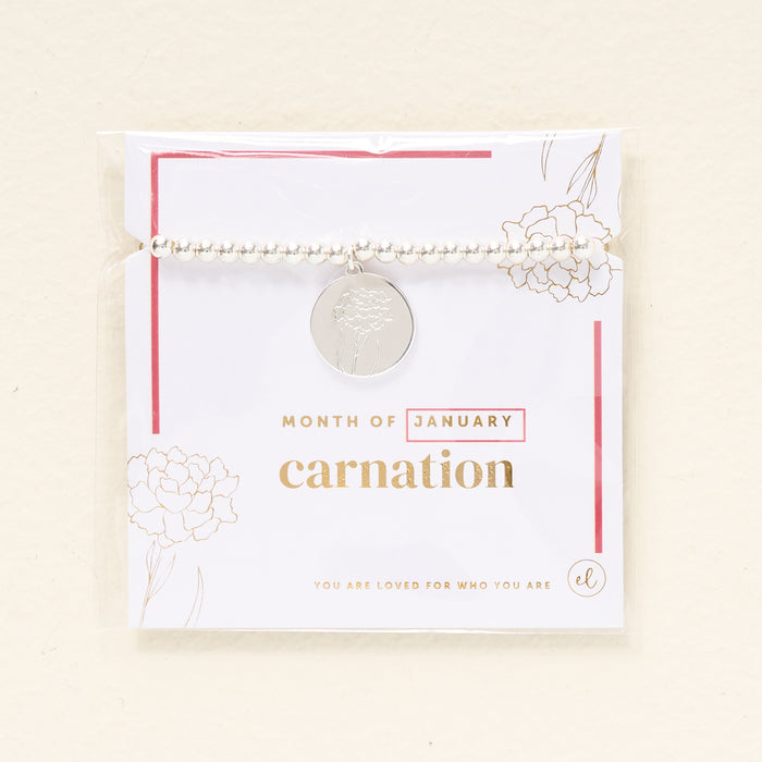 The Darling Effect Birth Flower Beaded Charm Bracelet features silver beads and a carnation charm, displayed on a "Month of January" card with gold floral designs and the message YOU ARE LOVED FOR WHO YOU ARE—a perfect gift.