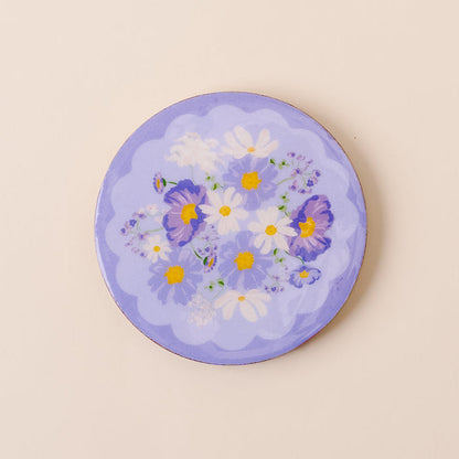The-darling-effect’s Bouquet Beauty Purple Wood Enamel Coaster features white daisies, yellow centers, and purple pansies on a periwinkle background with scalloped edges—a stylish and durable decorative piece.
