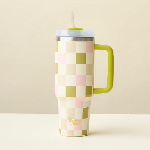The Darling Effect's Check Green 40 oz Take Me Everywhere Tumbler, featuring a yellow-green handle and straw with a white, pale pink, and light green checkered design, rests on a white surface against a beige background.