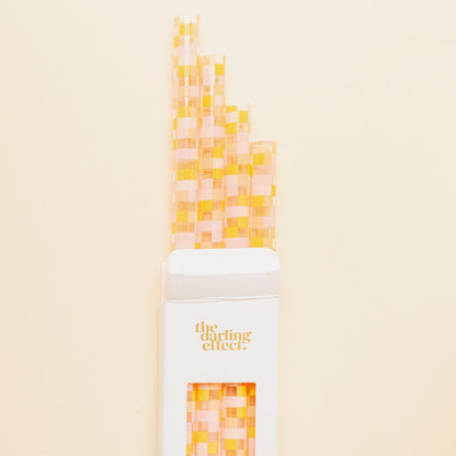 The Darling Effect Check Peach 40 oz Tumbler Straw Set features eco-friendly, reusable straws with a pink and yellow checkered pattern, packaged in a white box—perfect for your tumbler straw collection.