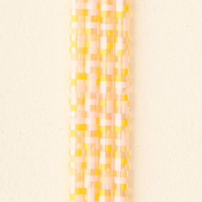 A vertical pattern of small rectangles in pastel yellow, pink, and cream on beige—ideal for presenting The Darling Effect’s Check Peach 40 oz Tumbler Straw Set.