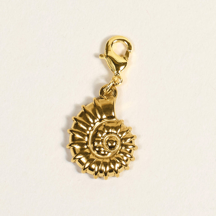 The Darling Effect's Conch Shell Jewelry Charm Gold features a detailed, ridged spiral shell design and lobster clasp—ideal for charm bars or as a unique jewelry accent. Shown on a plain white background.