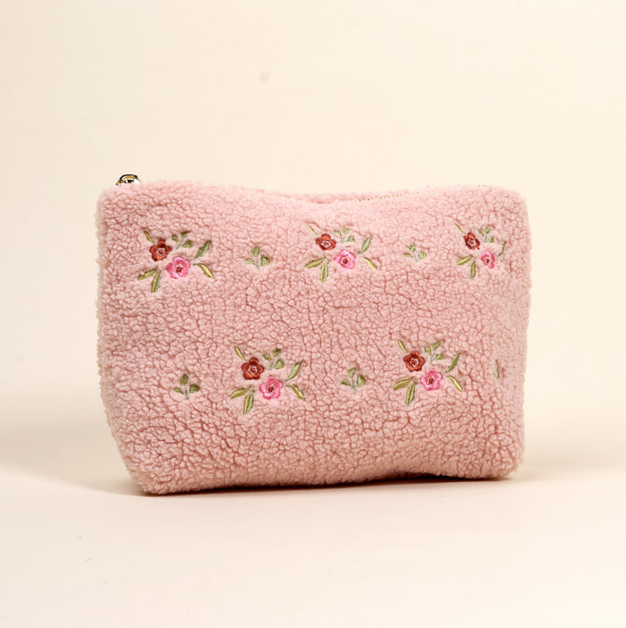 The Dainty Floral Pink Teddy Pouch by the-darling-effect features soft pink sherpa, embroidered pink and red flowers, and green leaves—a charming addition to our teddy pouches collection.