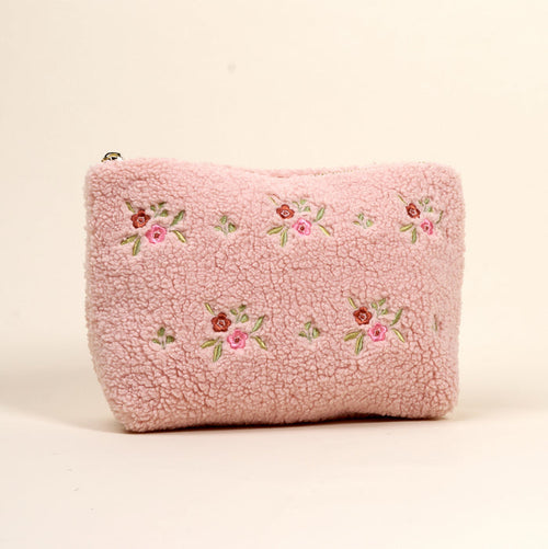 The Dainty Floral Pink Teddy Pouch by the-darling-effect features soft pink sherpa, embroidered pink and red flowers, and green leaves—a charming addition to our teddy pouches collection.
