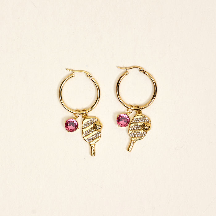 The Darling Effect's Dinking Around Signature Hoop Earrings feature popsicle-shaped charms with white rhinestones and a pink gem—perfect for adding a sparkling touch to your everyday look.
