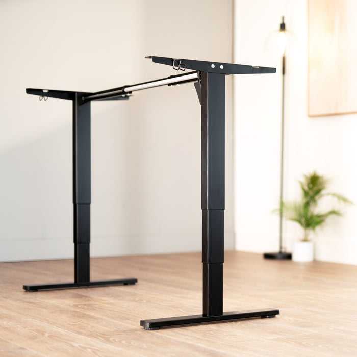 Heavy-duty sit or stand desk frame with adjustable height using touch screen control panel.