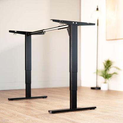Heavy-duty sit or stand desk frame with adjustable height using touch screen control panel.