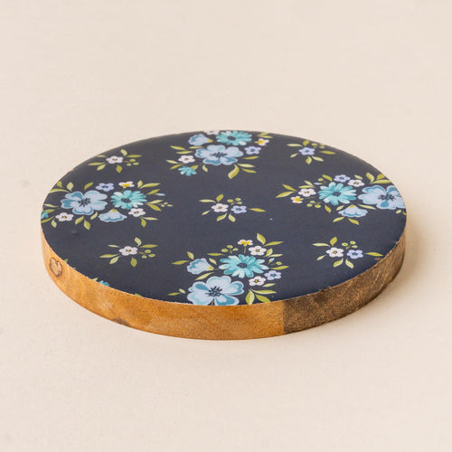 The Endless Daydream Navy Wood Enamel Coaster by the-darling-effect features a dark navy top with blue and teal floral bouquets, green leaves, natural wood sides, and a heart stamp—perfect as a durable decorative drink coaster.