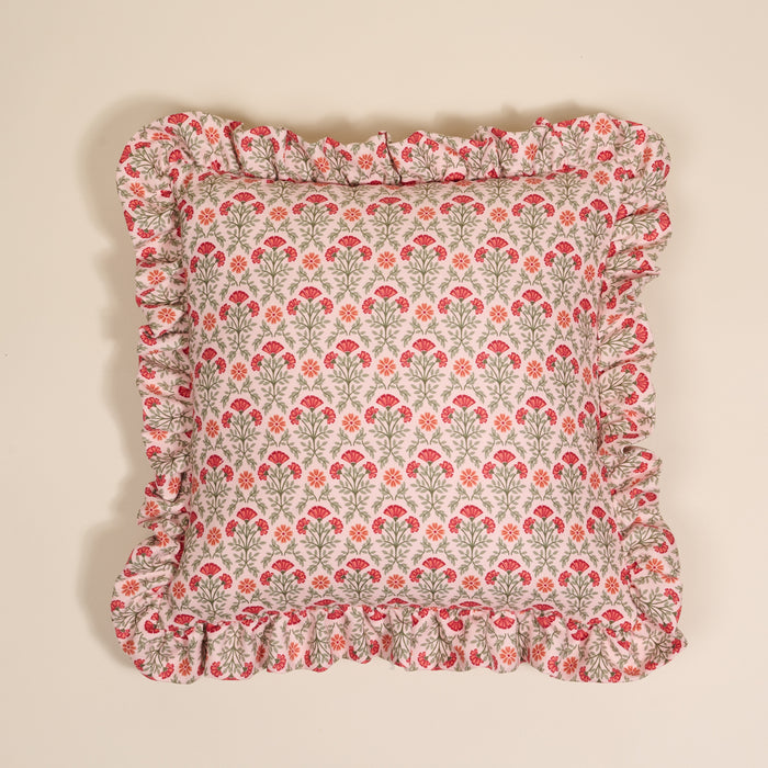 The Darling Effect’s Everbloom Dusty Rose Scalloped Square Throw Pillow features green stems and red-orange flowers with charming ruffled edges.