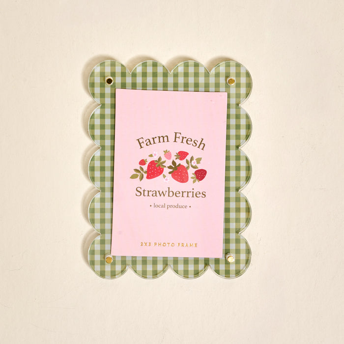 The Darling Effect Farm Fresh Strawberries Mini Acrylic Picture Frame Magnet features a green and white checkered scalloped border and displays a "Farm Fresh Strawberries" card with strawberry illustrations on a pink background.