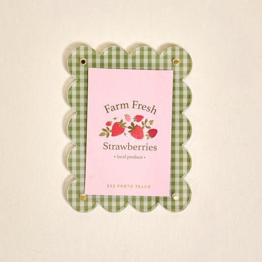 The Darling Effect Farm Fresh Strawberries Mini Acrylic Picture Frame Magnet features a green and white checkered scalloped border and displays a "Farm Fresh Strawberries" card with strawberry illustrations on a pink background.