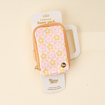 The Darling Effect's Flower Check Peach Tumbler Fanny Pack features a pink, peach, and yellow floral design, a water-resistant zippered pouch with a "Home" pin, and comes packaged as the Tumbler Fanny Pack.