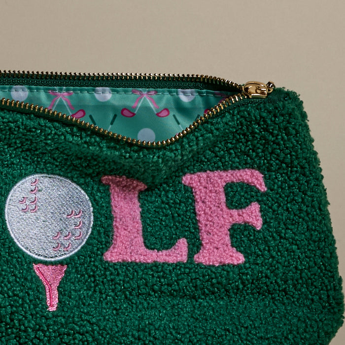 The Darling Effect’s Golf Teddy Pouch is a green textured zip pouch with stitched golf ball, tee, and pink "LF" details. Inside, its lining features playful golf clubs and balls on a light blue background—perfect as a stylish organizer.