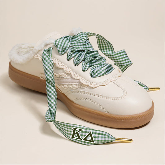 Add a pop of sorority style with Kappa Delta Step It Up Shoelaces by The Darling Effect—green and white gingham laces with lace trim, fuzzy lining, and the chapter letters K and Δ on the tips.