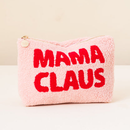 The Darling Effect’s Mama Claus Teddy Pouch is a fuzzy pink cosmetic bag with red embroidered “MAMA CLAUS” lettering and a gold zipper—perfect for festive travel or to brighten your Christmas teddy pouch collection.