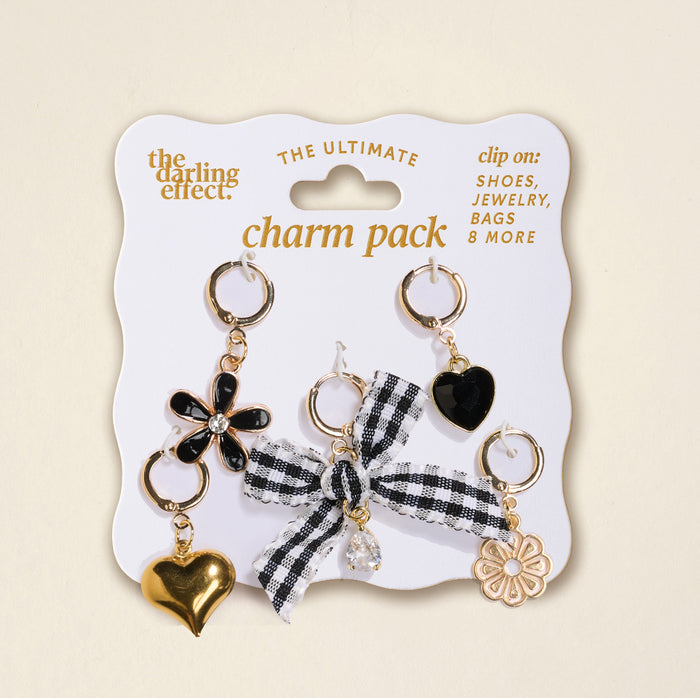 Midnight Moments The Ultimate Charm Pack by The Darling Effect features a black flower, gold heart, black heart, gingham bow with a clear gem, and gold flower—ideal for adding unique style to necklaces or scrunchie charm sets.