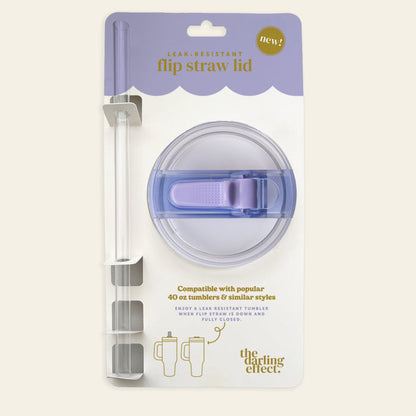 The Periwinkle 40 oz Lifestyle Flip Straw Lid by the-darling-effect features a round, clear lid with a purple flip top and straw. Leak-resistant and perfect for hydration on the go, it fits 40 oz tumblers and comes in branded packaging.
