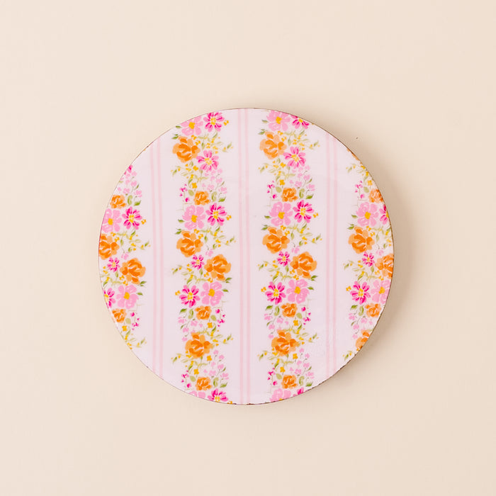 The-darling-effect's Petal Parade Pink Wood Enamel Coaster features pink and white stripes with floral clusters, adding charm to your table while protecting surfaces.