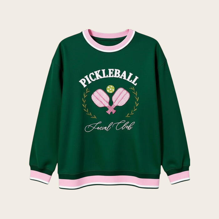 The Darling Effect's Pickleball Social Club Oversized Crew is a cozy green sweatshirt with pink and white trim, embroidered paddles, pickleball, "Pickleball Social Club" text, and a laurel wreath—perfect for your casual collection.