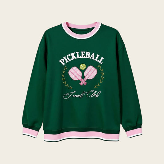 The Darling Effect's Pickleball Social Club Oversized Crew is a cozy green sweatshirt with pink and white trim, embroidered paddles, pickleball, "Pickleball Social Club" text, and a laurel wreath—perfect for your casual collection.