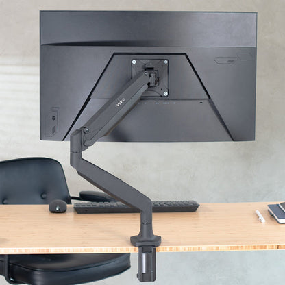 Pneumatic Arm Single Monitor Mount supporting a monitor on a desk setup.
