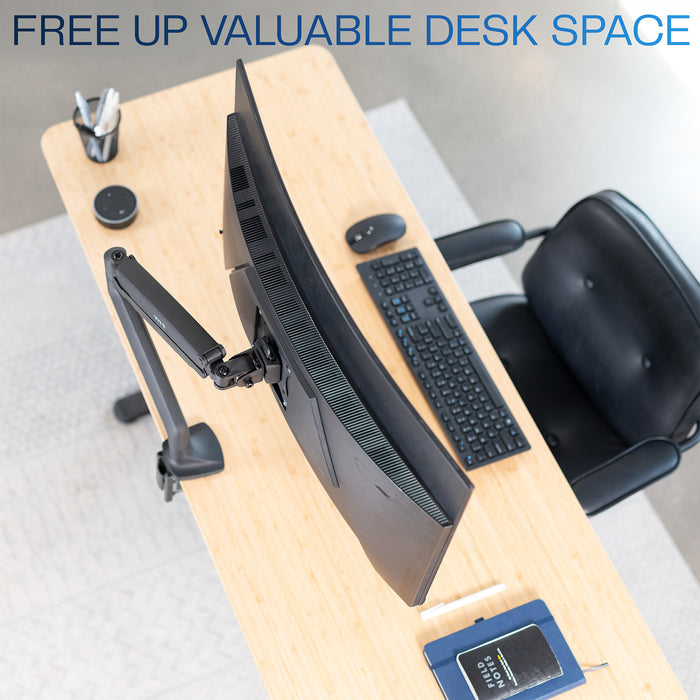 Wooden desk with monitor, keyboard, and chair in a modern office setup.