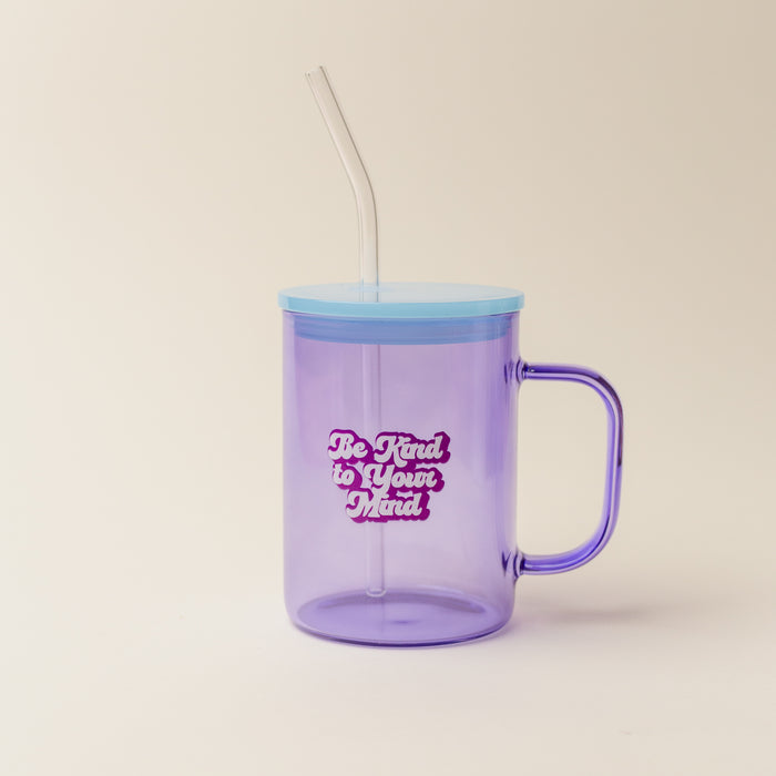 The Darling Effect’s Purple Be Kind To Your Mind Color Glass Mug with Handle features a blue lid, clear straw, and cheerful “Be Kind to Your Mind” white and pink bubble lettering—a vibrant way to brighten your day.