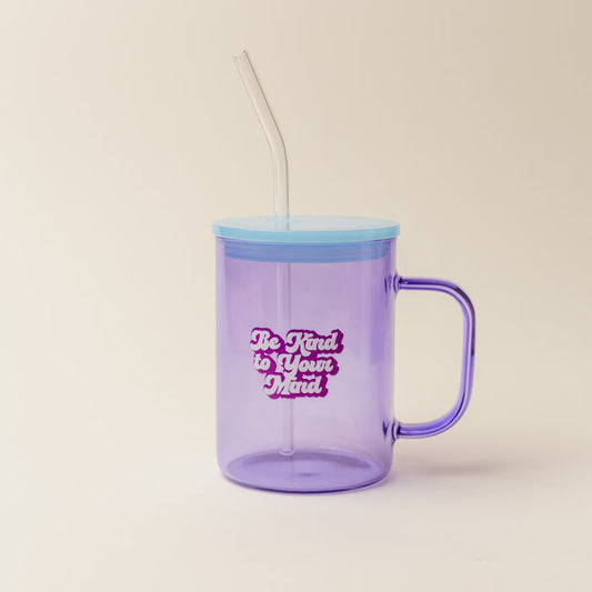 The Darling Effect’s Purple Be Kind To Your Mind Color Glass Mug with Handle features a blue lid, clear straw, and cheerful “Be Kind to Your Mind” white and pink bubble lettering—a vibrant way to brighten your day.