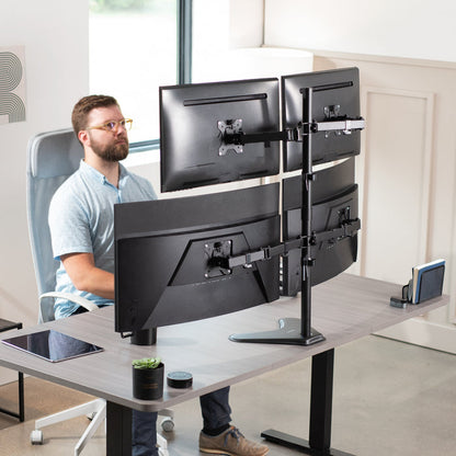 Quad Monitor Desk Stand holds 4 screens for work efficiency at your office desk. Features a freestanding base.