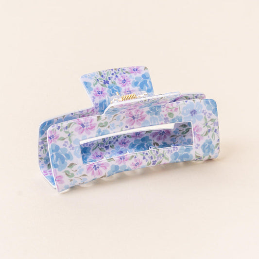 The Secret Garden Blue Claw Clip by the-darling-effect features a pastel floral print in blue, purple, and green on a light background, combining style with a strong hold for your hair.