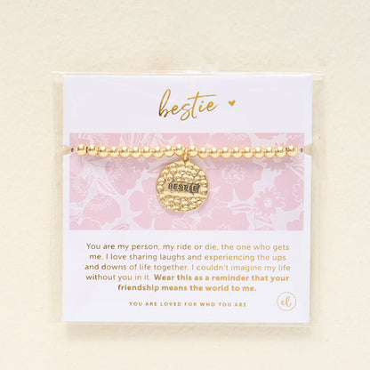 The Darling Effect Sentiment Beaded Charm Bracelet features gold beads, a hammered Bestie charm, and comes on a pink floral card with a friendship message—making it the perfect gift for your closest friend.