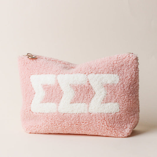 The Darling Effect’s Sigma Sigma Sigma Blush Teddy Letter Pouch features three bold white Sigma (Σ) letters on soft pink sherpa—an adorable and practical sorority accessory.