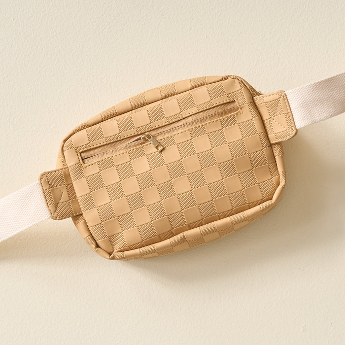 The Darling Effect’s Tan Urban Check Belt Bag features a white strap and vegan leather, shown from a top-down perspective.