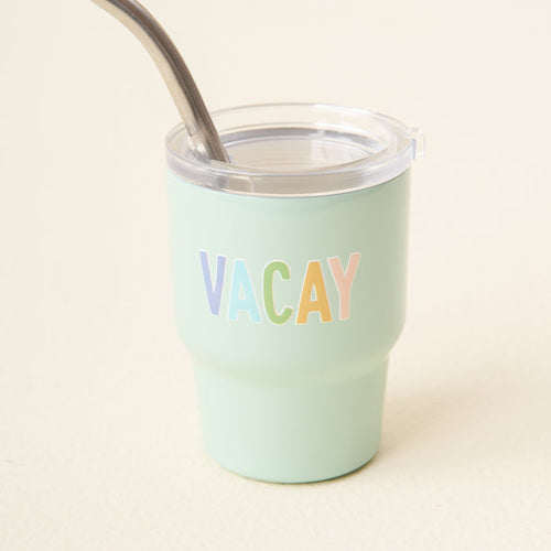 The-darling-effect's Vacay 2 oz Tiny Tumbler is mint green with a clear lid, metal straw, and features "VACAY" in pastel-colored letters on the front.