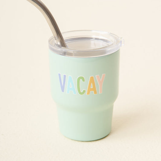 The-darling-effect's Vacay 2 oz Tiny Tumbler is mint green with a clear lid, metal straw, and features "VACAY" in pastel-colored letters on the front.