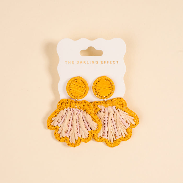 The Darling Effect’s Yellow Cabana Breeze Earrings feature yellow raffia shells with pink and cream fringe—lightweight, boho, and perfect for everyday wear.