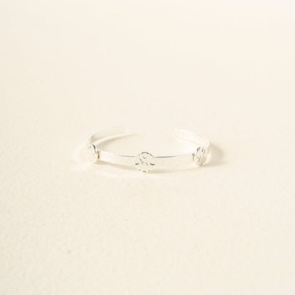 The Darling Effect’s You Are Loyal Skinny Stacker Trait Bracelet is a minimalist silver adjustable cuff with three evenly spaced motifs, shown on an off-white background—perfect as a gift-ready jewelry piece.