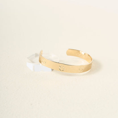 The Darling Effect's "You Are Strong" Cuff Bracelet features engraved geometric patterns, an inner "You Are Strong" inscription, and an adjustable fit—blending elegance with personal inspiration.