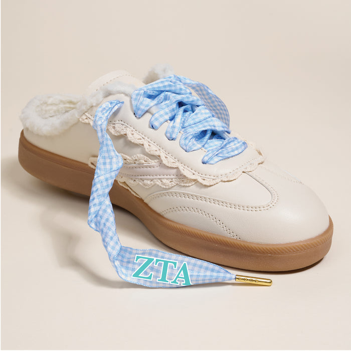 The Darling Effect's Zeta Tau Alpha Step It Up Shoelaces feature blue and white gingham laces, fuzzy lining, a lace detail, and turquoise-and-white ZTA tips—perfect for gifting your favorite sorority member.