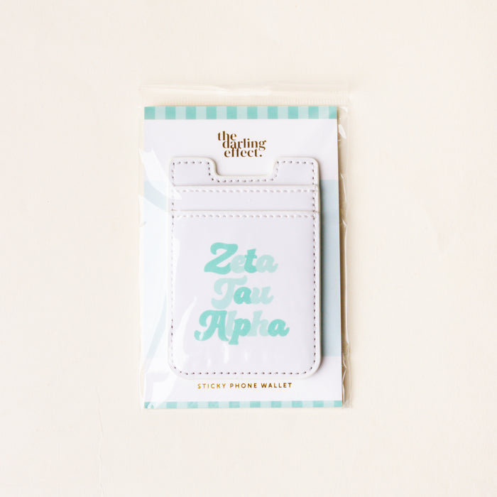 The Darling Effect’s Zeta Tau Alpha Stick-On Phone Wallet features “Zeta Tau Alpha” in light blue on white, comes with a teal and white striped backing card—an ideal sorority accessory and thoughtful gift.
