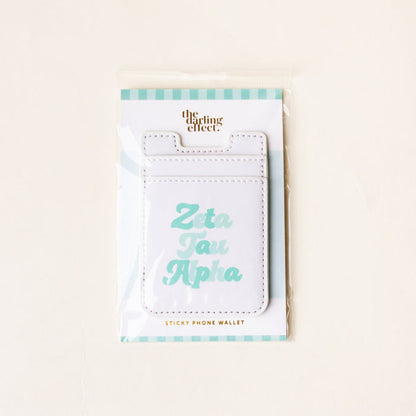 The Darling Effect’s Zeta Tau Alpha Stick-On Phone Wallet features “Zeta Tau Alpha” in light blue on white, comes with a teal and white striped backing card—an ideal sorority accessory and thoughtful gift.