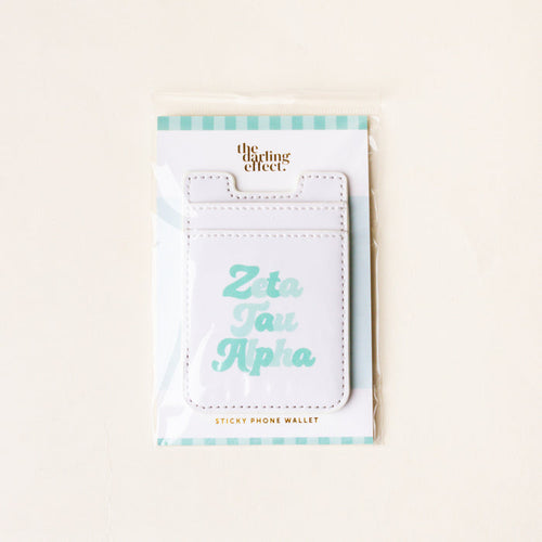 The Darling Effect’s Zeta Tau Alpha Stick-On Phone Wallet features “Zeta Tau Alpha” in light blue on white, comes with a teal and white striped backing card—an ideal sorority accessory and thoughtful gift.