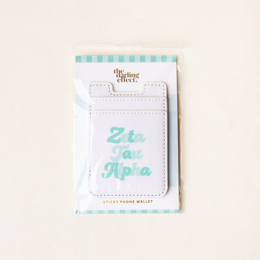 The Darling Effect’s Zeta Tau Alpha Stick-On Phone Wallet features “Zeta Tau Alpha” in light blue on white, comes with a teal and white striped backing card—an ideal sorority accessory and thoughtful gift.